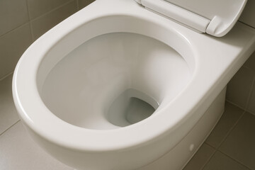 A clean, white porcelain toilet bowl in a modern bathroom setting.