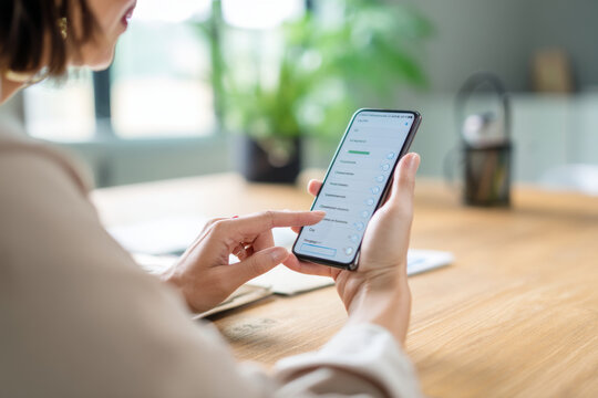 Mature Hispanic businesswoman creating feedback surveys for internal evaluation, customizing options in a sleek app interface