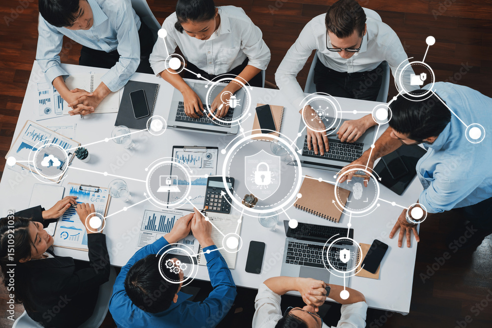 Poster A group of professionals engages in a collaborative meeting, focusing on technology and security strategies while analyzing data visualizations in a modern office setup. Amity