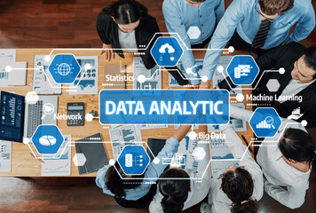 A diverse team engages in a collaborative data analytic session, discussing insights and strategies using advanced technology in a modern office setting. Amity