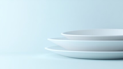 Stacked white plates on light blue background