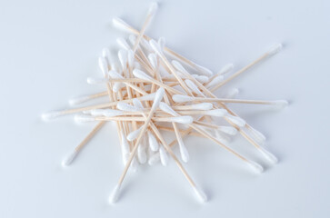 Cotton swabs lying in a pile on a white background