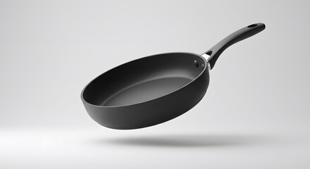 Elegant Black Frying Pan Floating on White Background: A Culinary Still Life