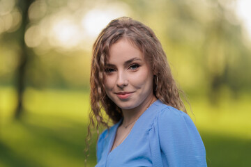 Beautiful Girl with long hair posing in sunbeams in park