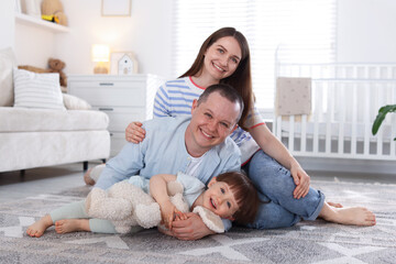 Obraz premium Cute little boy and his parents at home. Lovely family