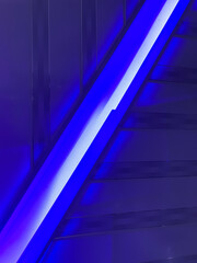 Diagonal abstract architectural detail with intense blue neon lighting and futuristic lines...