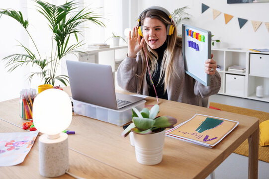 Teacher Tana is teaching online. She's using a whiteboard and her laptop to connect with students. She's making learning fun and accessible from home..