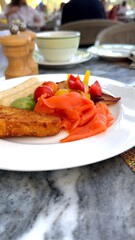 Plate of crispy hash brown beside colorful pickled salad and sliced avocado, soft lighting...