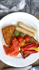 White sausages, crispy hash brown, grilled vegetables, cherry tomatoes, and smoked salmon arranged with vibrant contrast, perfect for healthy mornings, ideal tourist attraction view.