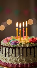 A beautifully decorated birthday cake topped with candles and flowers stands ready for celebration