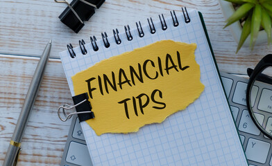 A notebook with the word financial tips written on it