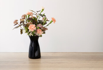 summer flowers in black vase on white background
