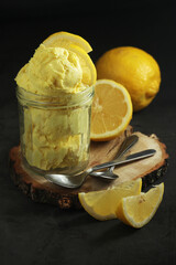 Lemon ice cream scoops in glass jar	