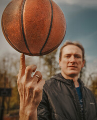 A player holds an outside basketball in his hand