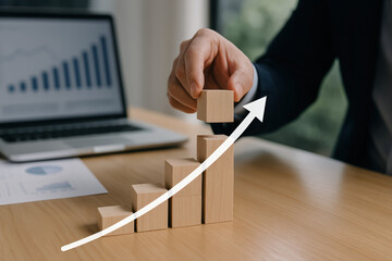 Strategic Business Growth Visualized Through Stacked Wooden Blocks Representing Increasing Trends and Financial Progression in a Professional Environment