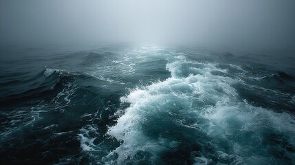 Fototapeta premium A vast expanse of water, with rolling waves, surrounded by a hazy atmosphere