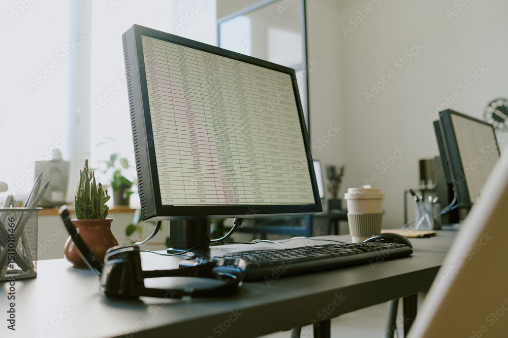 Wall mural office workspace featuring monitor displaying spreadsheet with coffee cup, keyboard, and headphones 