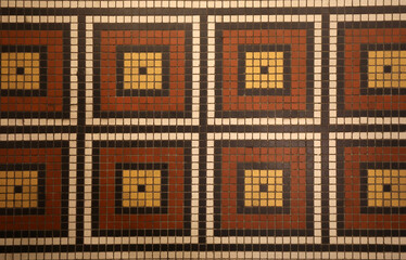 Mosaic floor with multicolored small square tiles with an abstract pattern