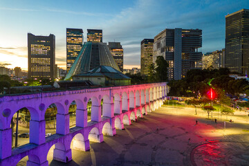Lapa Aqueduct Illuminated With Purple and Pink Colors in the Evening With Tall Office Buildings of Rio de Janeiro Downtown