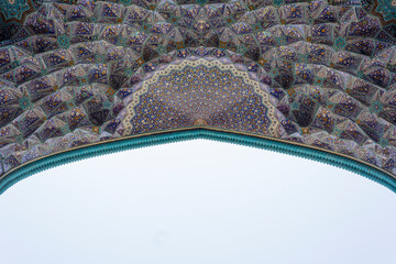 Intricate tilework and geometric patterns of the Shah Mosque in Esfahan, Iran, showcasing stunning Persian craftsmanship and vibrant Islamic art.
