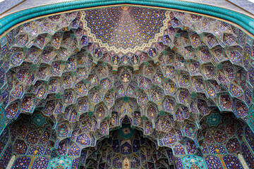 Intricate tilework and geometric patterns of the Shah Mosque in Esfahan, Iran, showcasing stunning Persian craftsmanship and vibrant Islamic art.
