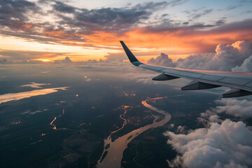 Fototapeta premium Airplane Wing View at Sunset Over Clouds
