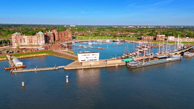 Approaching the port of picturesque Lelystad, the Netherlands on the lake Markermeer. Old ships and modern yachts stand at the berths. Aerial view.