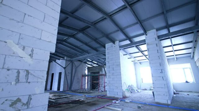 New bulkheads of white bricks built to support the roof of. Attic floor of the building under reconstruction.