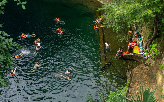 Visitors swimming in Mayan cenote natural pools in the town of Valladolid, Yucatan, Mexico