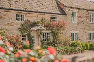Cottages in the sun with roses in Northamptonshire