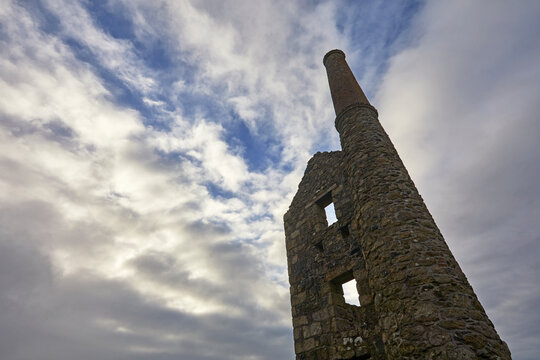 The ruined engine house of Carn Galver tin mine against the afternoon light, near Pendeen, Cornwall, United Kingdom