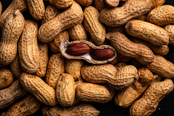 Pile of peanuts with one opened pod