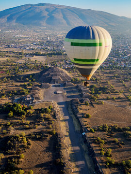Hot air balloon flying over the Avenue of the Dead and the Pyramid of the Moon at sunrise, aerial view, Teotihuacan, Mexico State, Mexico