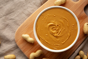 Organic Peanut Butter in a Bowl, top view. Flat lay, overhead.