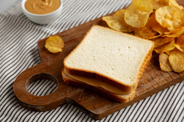 Homemade American Peanut Butter Sandwich on a Wooden Board, side view.