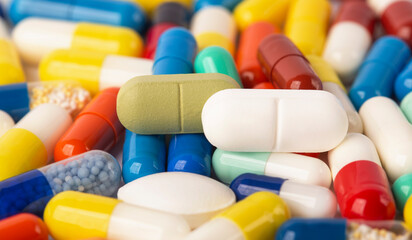 many colored pills close-up red, blue, yellow