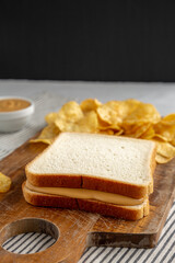 Homemade American Peanut Butter Sandwich on a Wooden Board, side view.