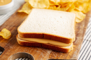 Homemade American Peanut Butter Sandwich on a Wooden Board, side view.