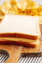 Homemade American Peanut Butter Sandwich on a Wooden Board, side view.