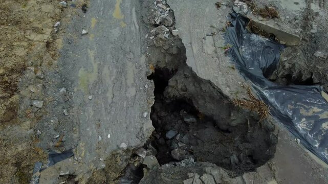 Aerial footage of the place where the Corund River enters the salt mine in Praid, Harghita County - Romania. The hole where the water floods into the Praid salt mine