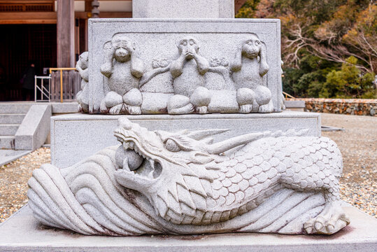 Stone statue of the Three wise monkeys on a dragon at Minoh National Park near Osaka, Kansai Japan