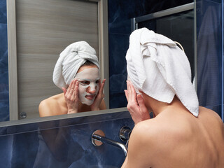 Woman put face mask at bathroom
