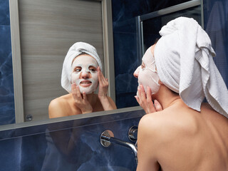 Woman put face mask at bathroom