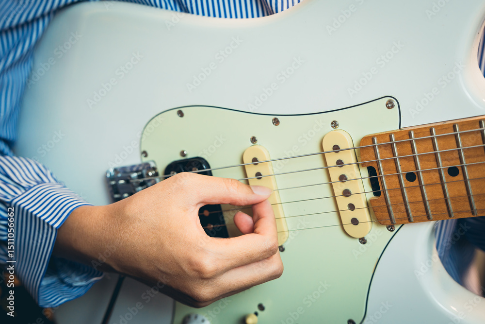 Poster guitarist concept. close-up of a person playing electric guitar with attention to detail on strings 