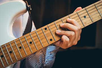 Guitarist concept. Close-Up of Hand Playing Guitar Strings with Focus on Musical Expression and...