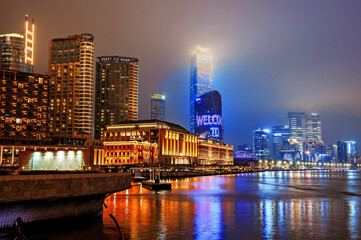 Brightly lit Shanghai city view at night shrouded in mist at the Bund, Shanghai, China