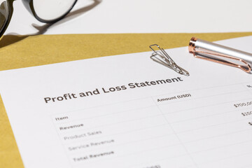 Profit and Loss Statement with Pen and Eyeglasses – Business Financial Review on Desk

