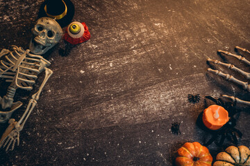 Halloween flat lay. Festive Halloween Scene with Skeleton, Pumpkins, Spider, Candle, and Decorative...