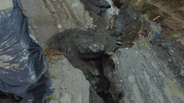 Aerial footage of the place where the Corund River enters the salt mine in Praid, Harghita County - Romania. The hole where the water floods into the Praid salt mine