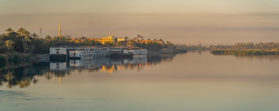 View of reflections in the Nile River at dawn at Al Daba 'Eya near Luxor, Luxor, Egypt, Africa